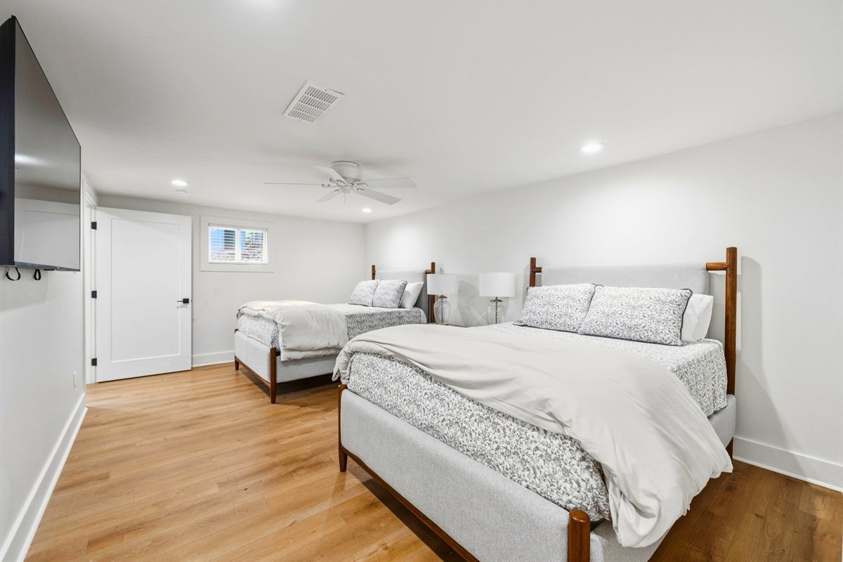 Bright windows and comfortable furnishings make this bedroom another inviting place for guests to relax and recharge.