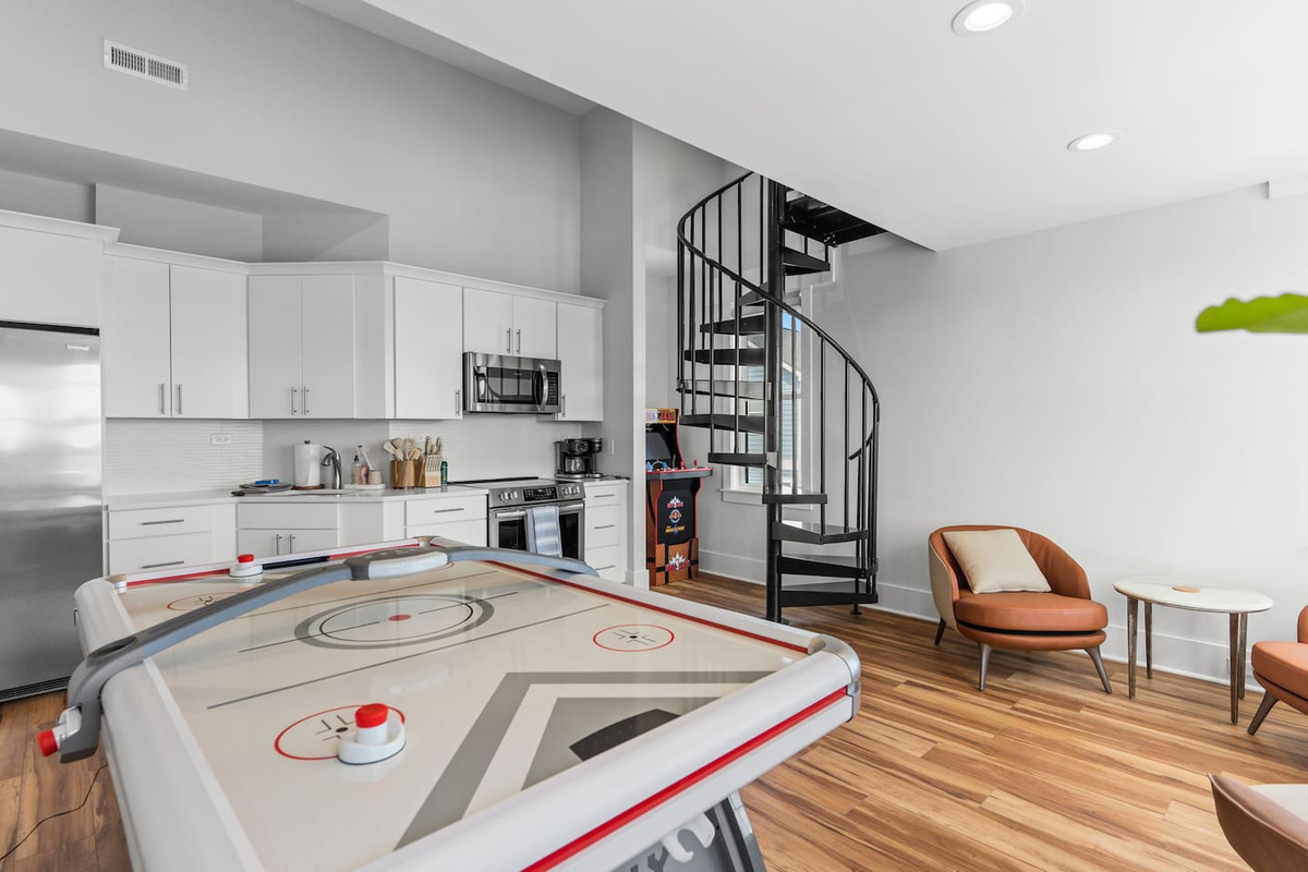 The upstairs game room's full kitchen adds an extra layer of convenience, complete with a refrigerator, range and oven, microwave, and sink - perfect for keeping snacks, drinks, and meals close to the action.