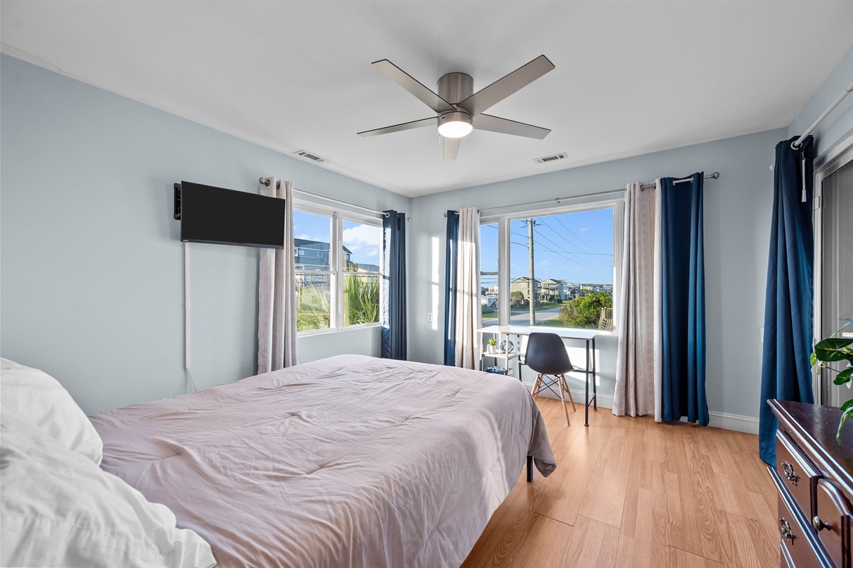 Work from vacation with ease in this queen bedroom complete with desk area