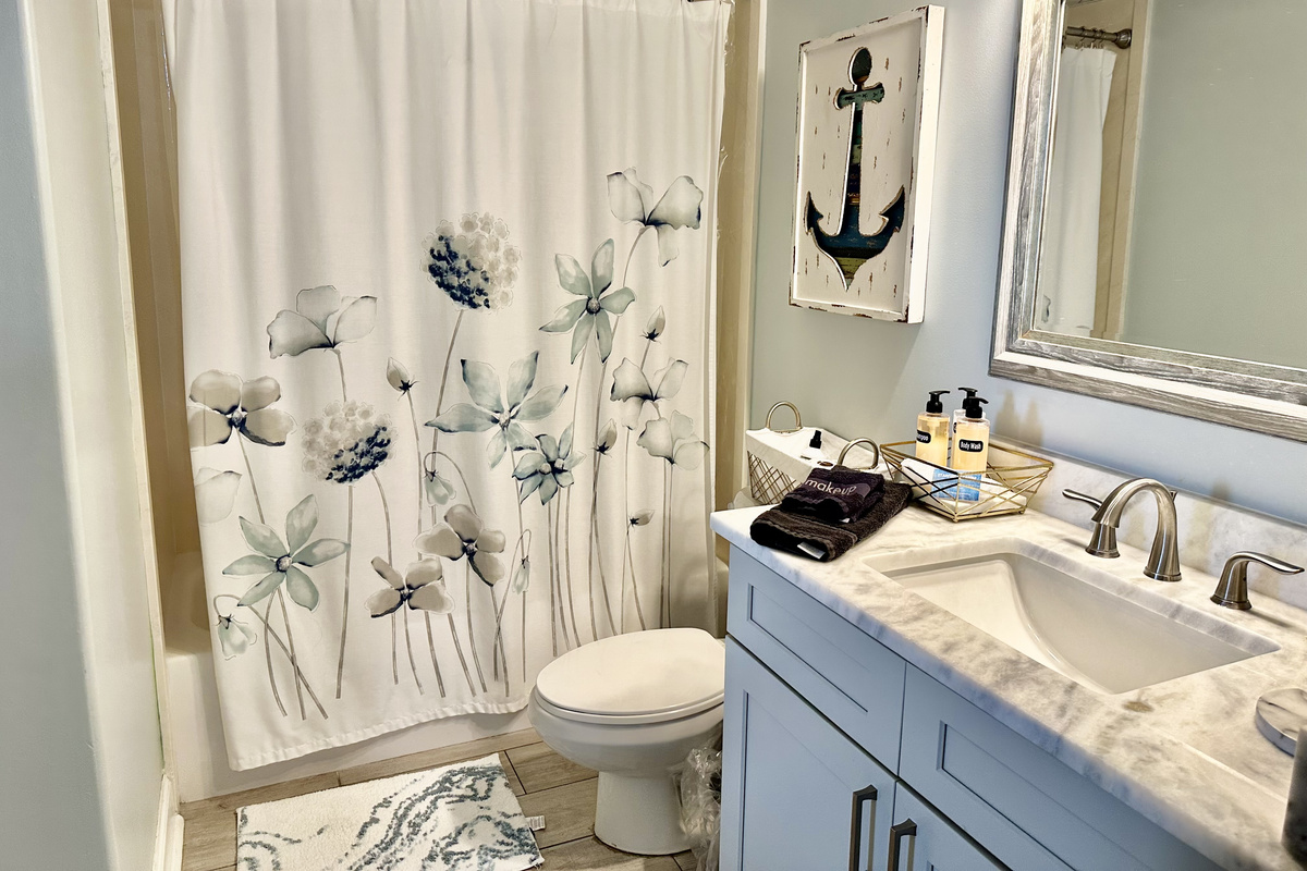The guest bath is accessible from both the guest bedroom and hallway!  It offers a tub/shower combo.