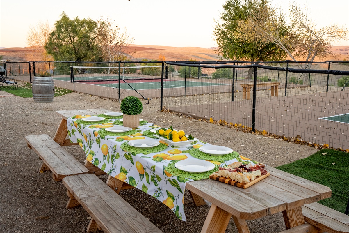 Outdoor dining by the pickleball courts. Comfortably seats up to 12 guests.