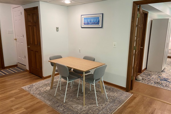 Dining area with view of the supply closet (brown door) and locked stairs to the owner's portion of the house (white door).