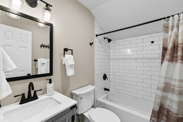 2nd floor corridor full bathroom stocked hand soap, and a full tub-and-shower combination