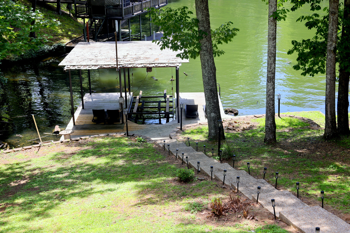 Wilson Lake waterfront view with walkway to the dock area and peaceful wooded surroundings