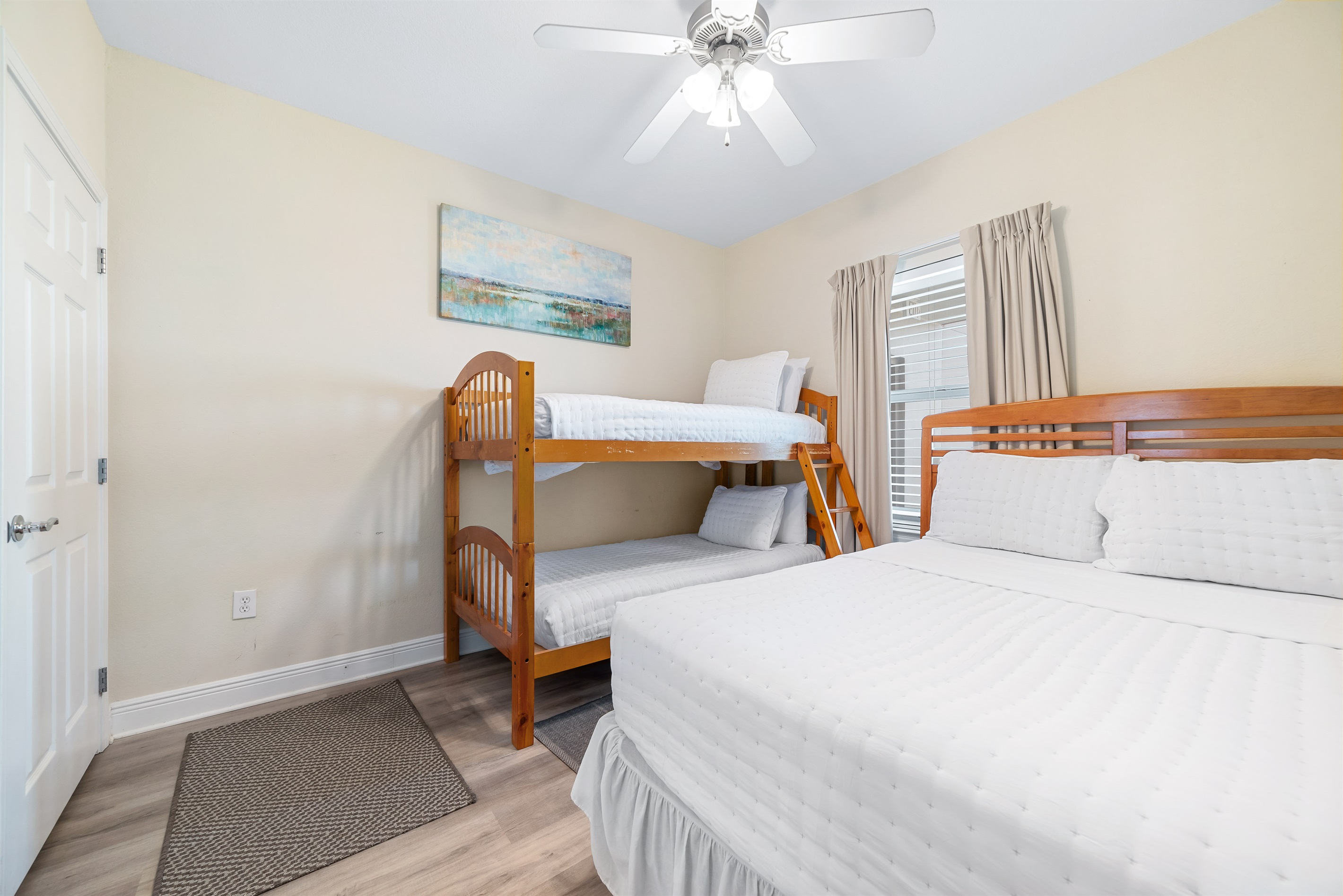 A cozy and inviting guest room with 1 queen-size bed and 1 bunk bed, perfect for creating memories and enjoying a comfortable stay. This space offers a blend of functionality and style.