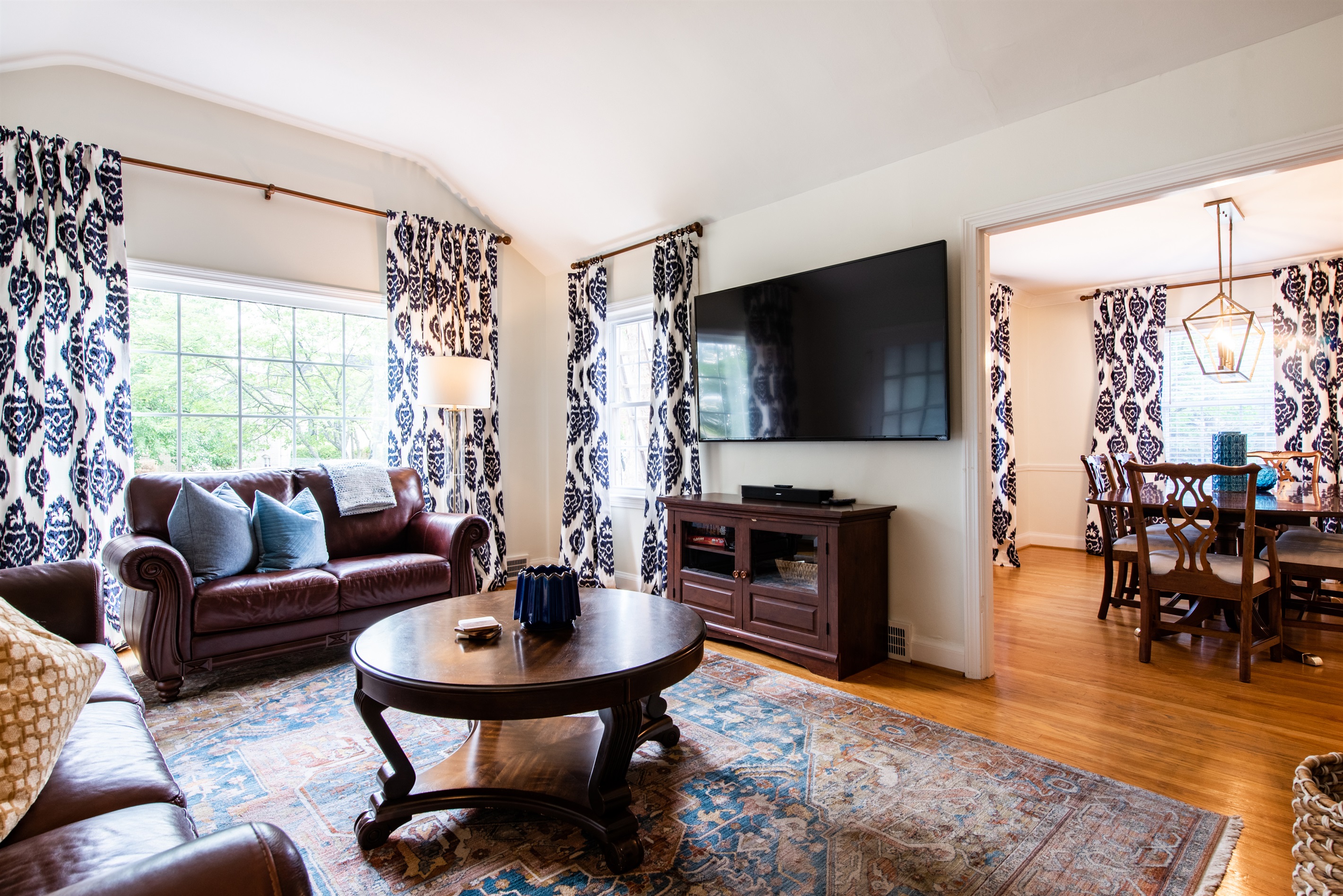 Enjoy a cozy night in after the Bourbon Trail in this living room with a big screen TV that opens to the dining room! Perfect for sipping bourbon.