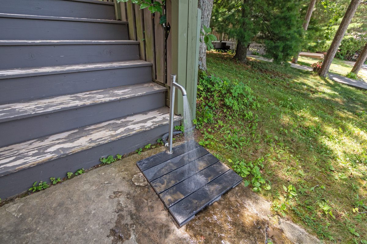 A convenient foot washing station at the top of the stairs makes it easy to rinse off before relaxing on the deck or heading inside.
