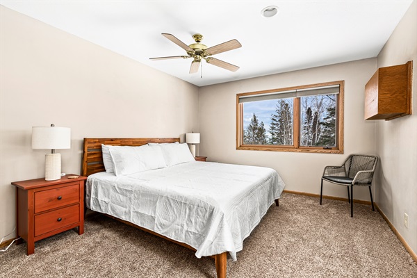 Welcoming second basement bedroom with a king bed, USB chargers conveniently placed on the nightstands, and a Nest thermostat to ensure personalized comfort. A peaceful retreat designed for relaxation