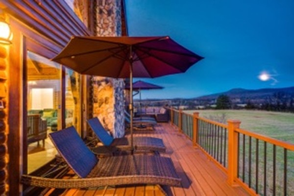 Unwind on the expansive deck at dusk, where mountain views, moonlit skies, and cozy loungers invite you to soak in the magic.