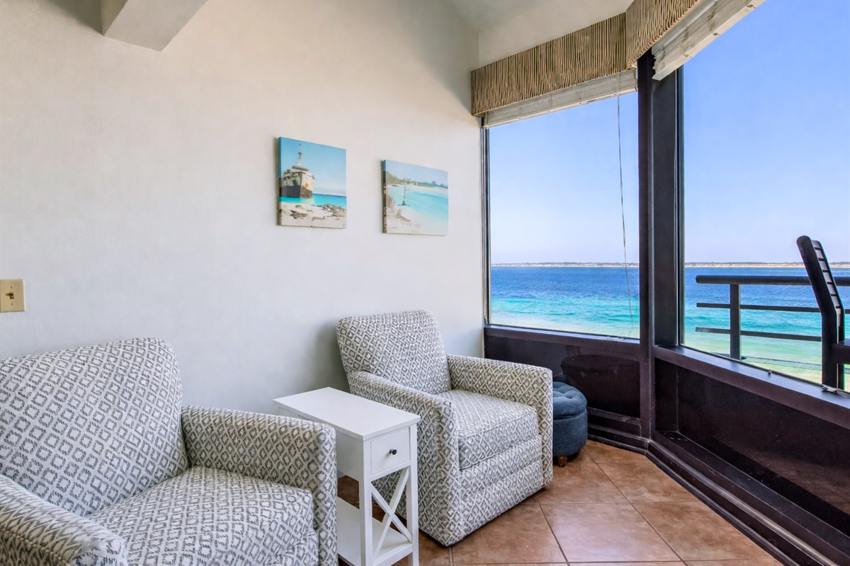 Tucked by the window, this peaceful sitting area offers a quiet place to unwind with water views.