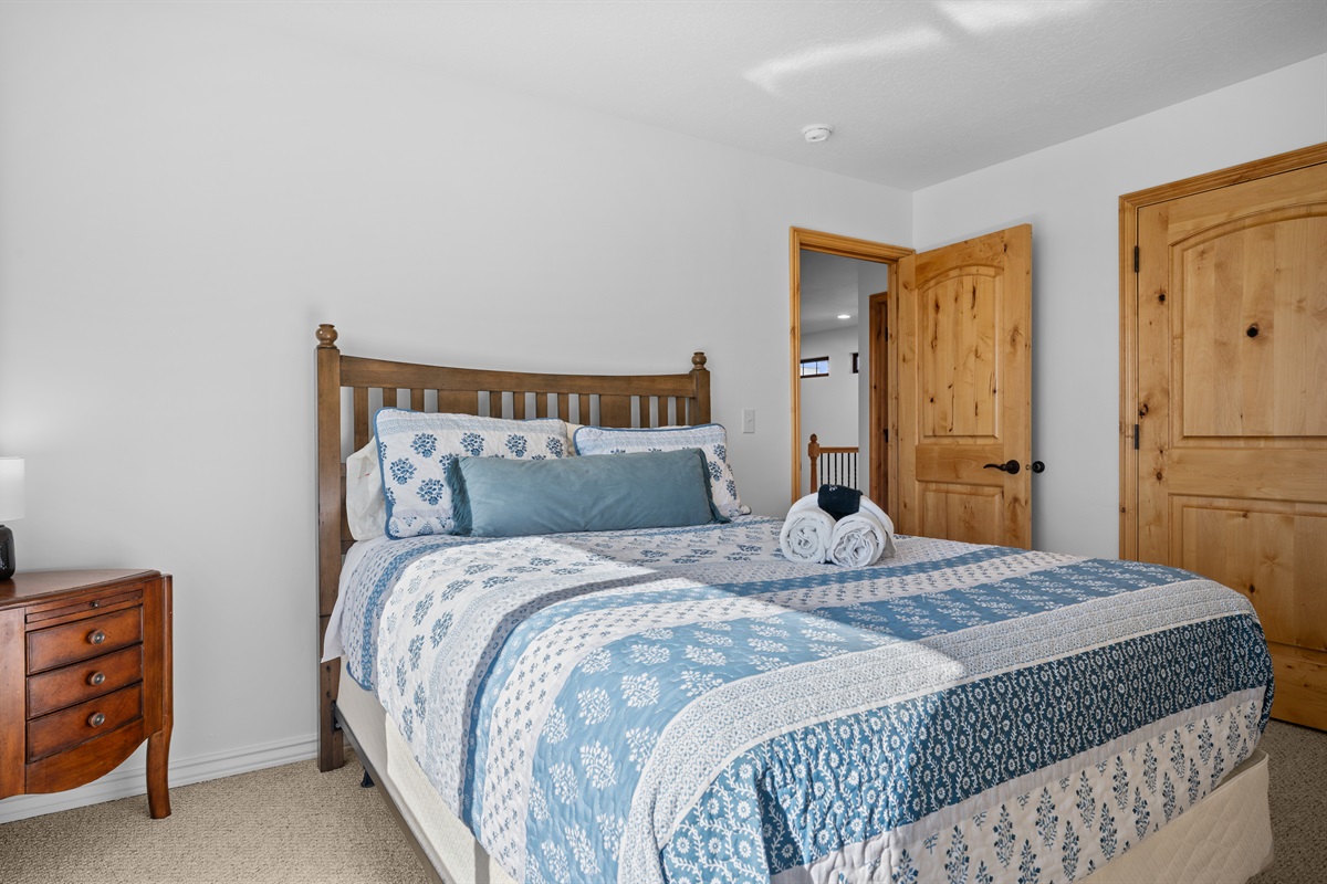 The third bedroom is outfitted with a king bed, luxurious linens, and plush pillows.