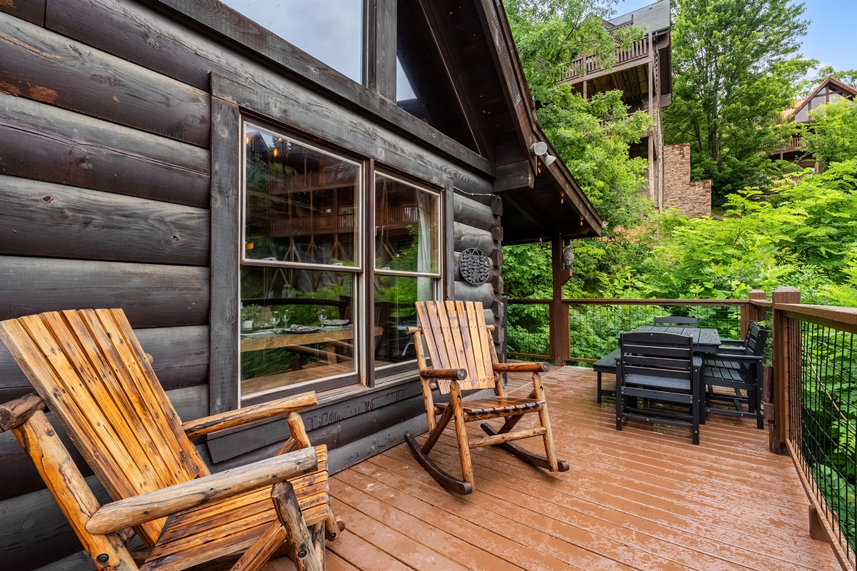 Take in views of the community pool from the spacious deck, complete with outdoor dining for six and two rustic rocking chairs