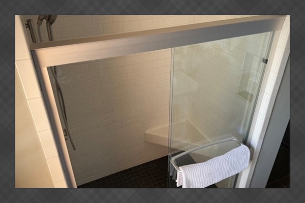 The enormous shower has a built-in tiled bench.