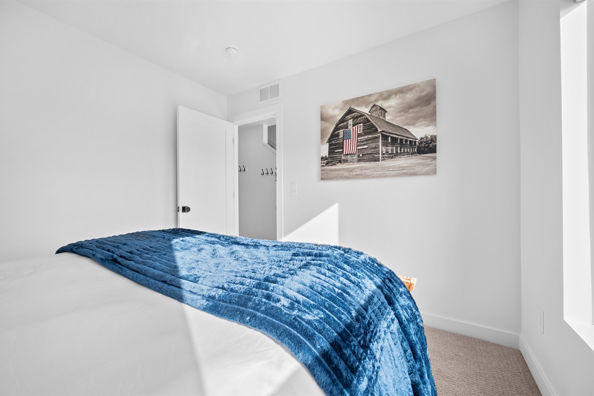Guest bedroom on the first level with stylish décor and soft linens.