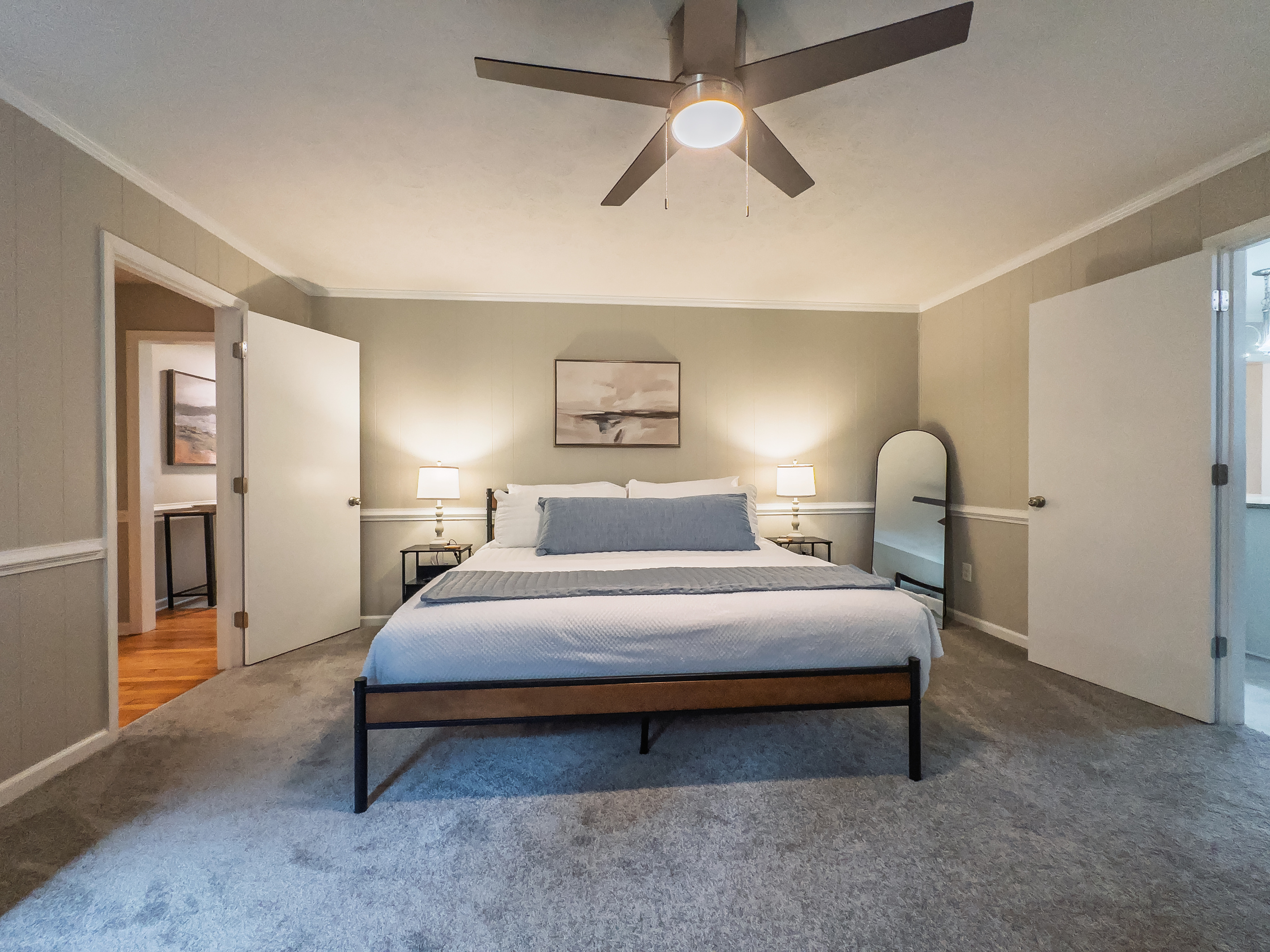 King bed, 55" Smart TV, ceiling fan, two led light nightstands with multiple charging ports, two multi light function lamps, blackout curtains, dresser, wardrobe closet, full length mirror, stylish brick fireplace - not in use.