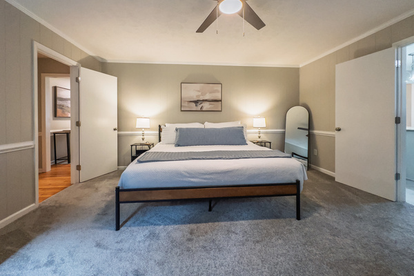King bed, 55" Smart TV, ceiling fan, two led light nightstands with multiple charging ports, two multi light function lamps, blackout curtains, dresser, wardrobe closet, full length mirror, stylish brick fireplace - not in use.