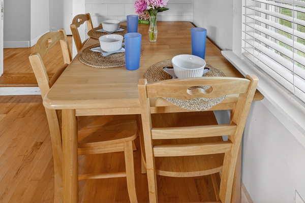 Cozy breakfast nook with seating for four—ideal for morning coffee, quick meals, or family game time.