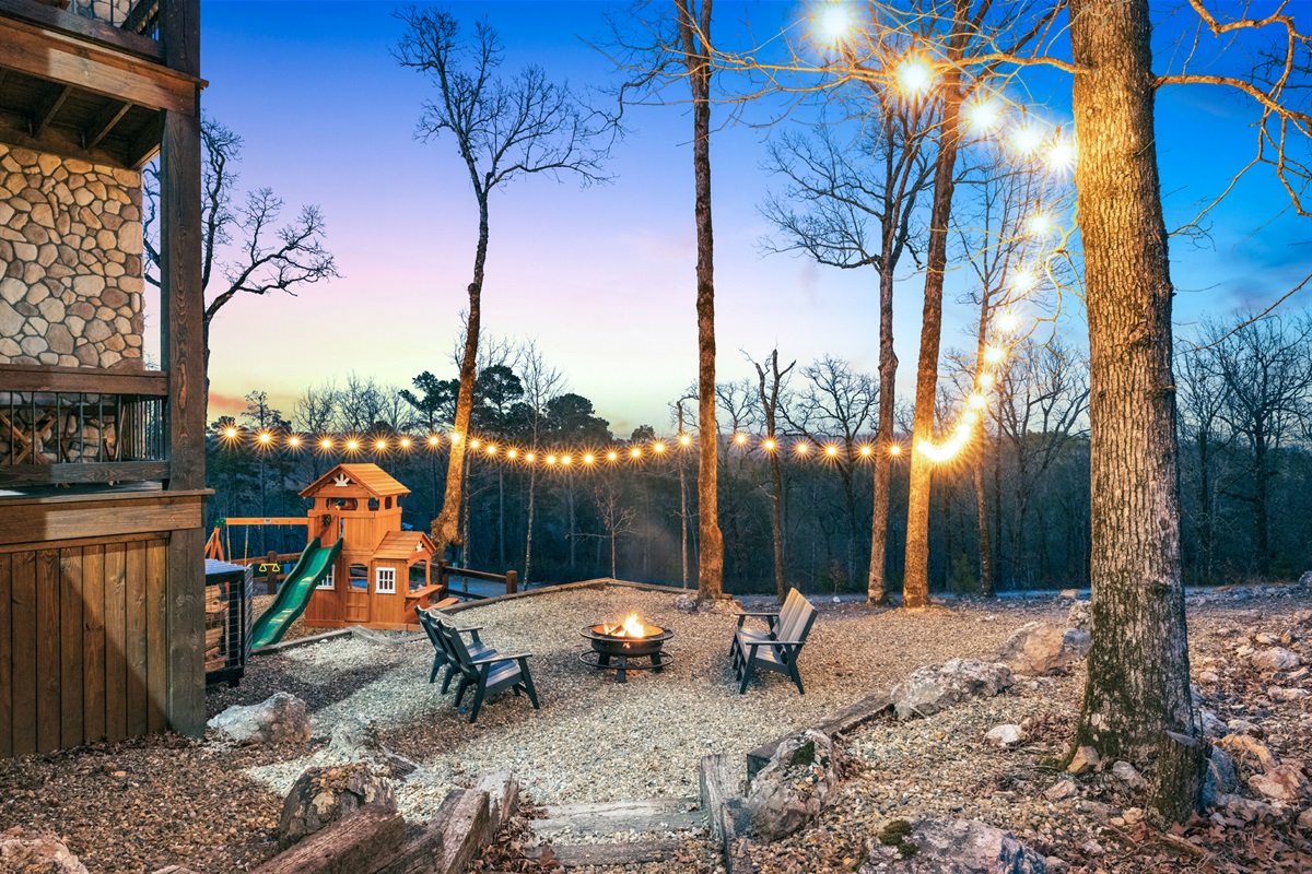 Magical fire pit setting with string lights and peaceful woodland surroundings