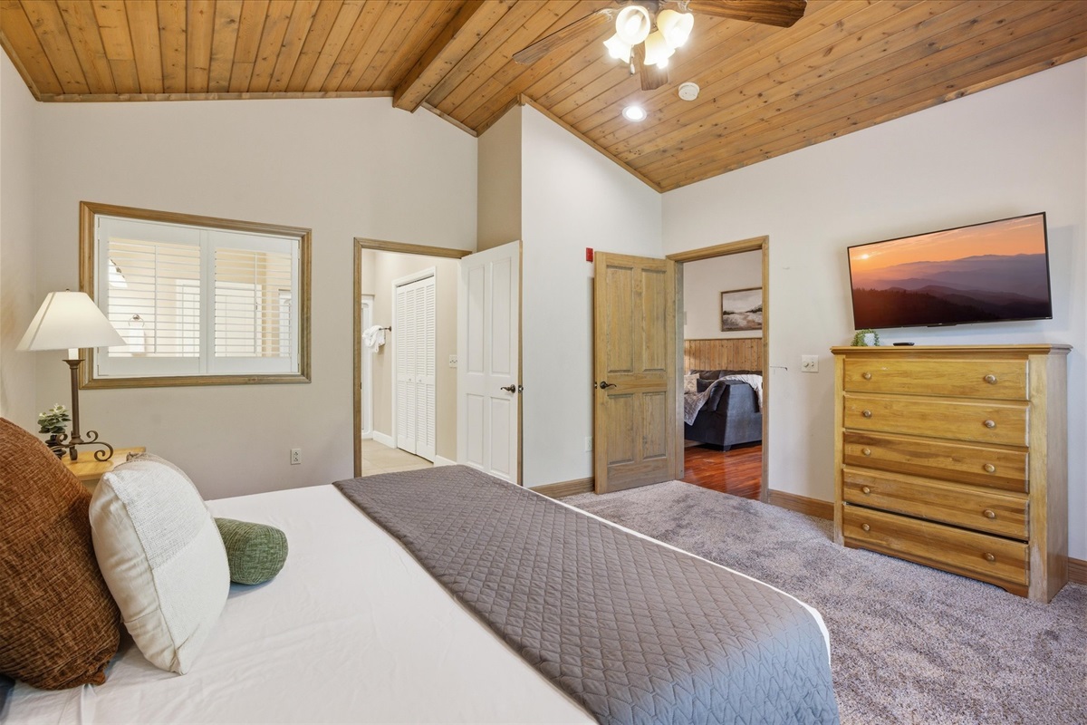 Relax in Unit 322’s master bedroom, offering plenty of space and a calm, inviting feel for a restful stay.