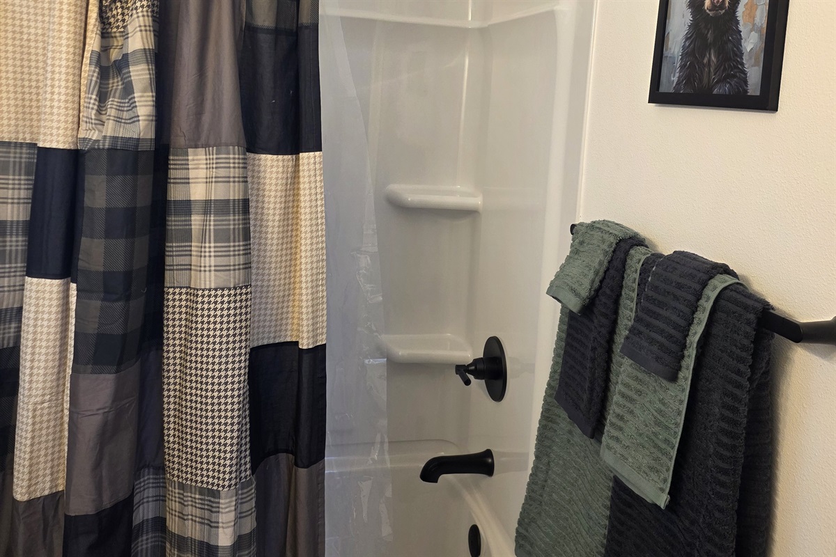 Bathroom includes a vanity, toilet, and shower/tub combo.