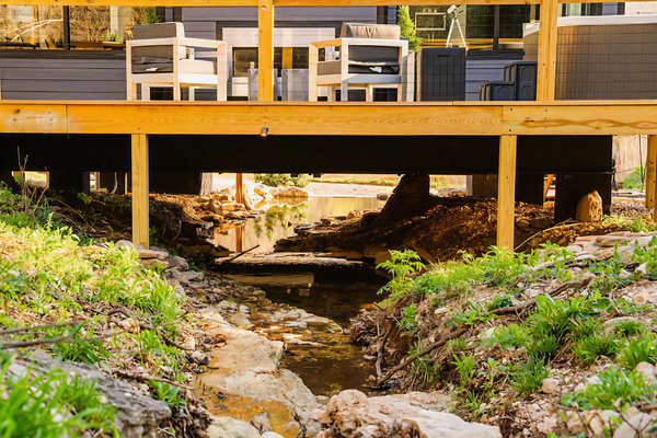 The creek isn't nearby - it's beneath you. Stay in a modern cabin built OVER private spring-fed creek where you're never far from the sight & sound of natural flowing water, whether indoors or out.