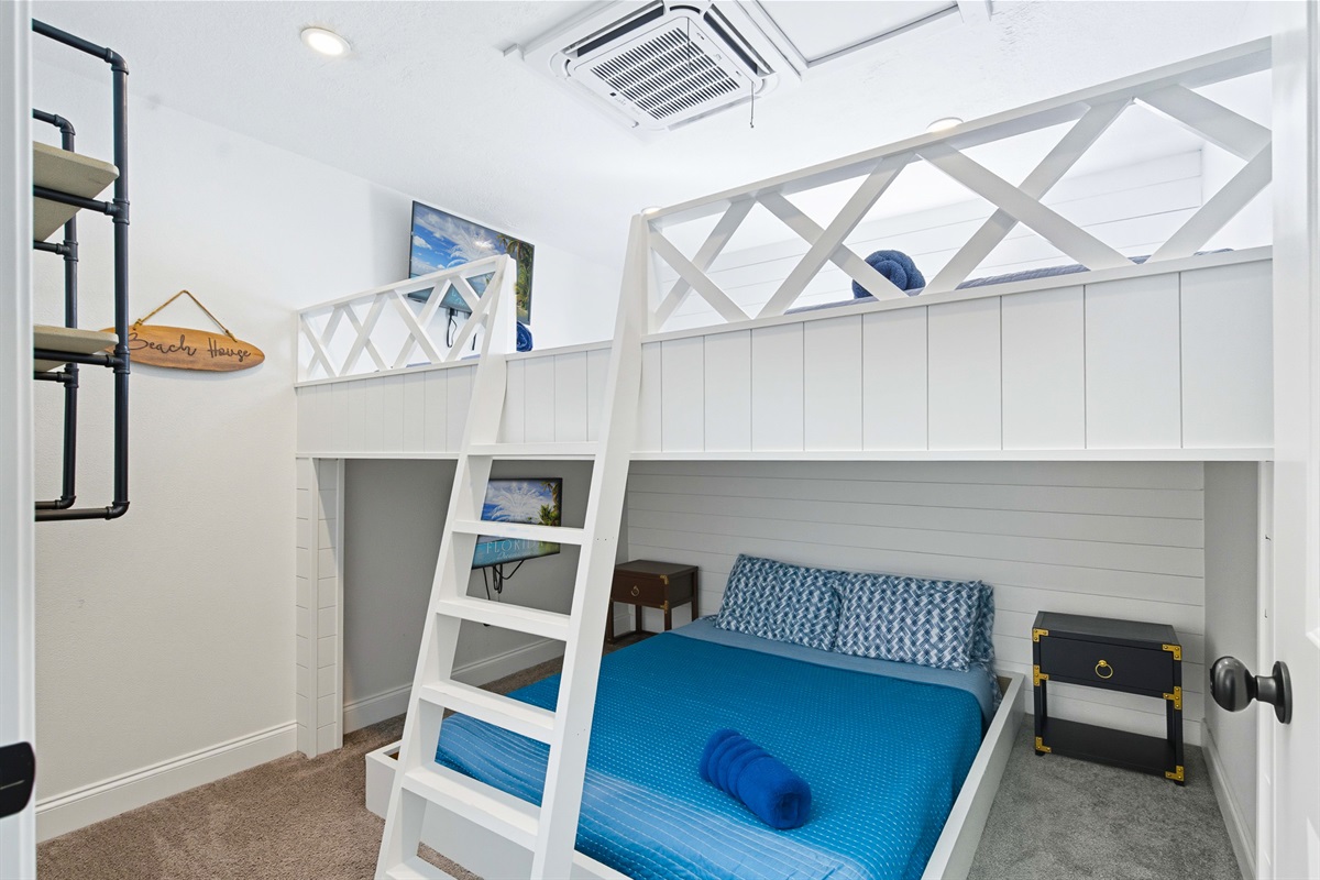 The second floor bunk room offers two full beds over a queen bed.