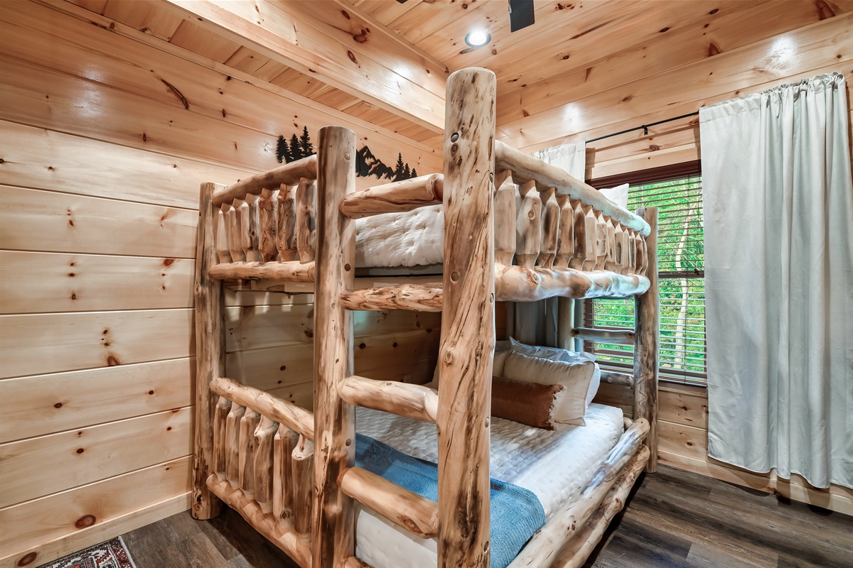 Bedroom with queen bunk bed, en-suite bathroom and 32 inch smart TV.