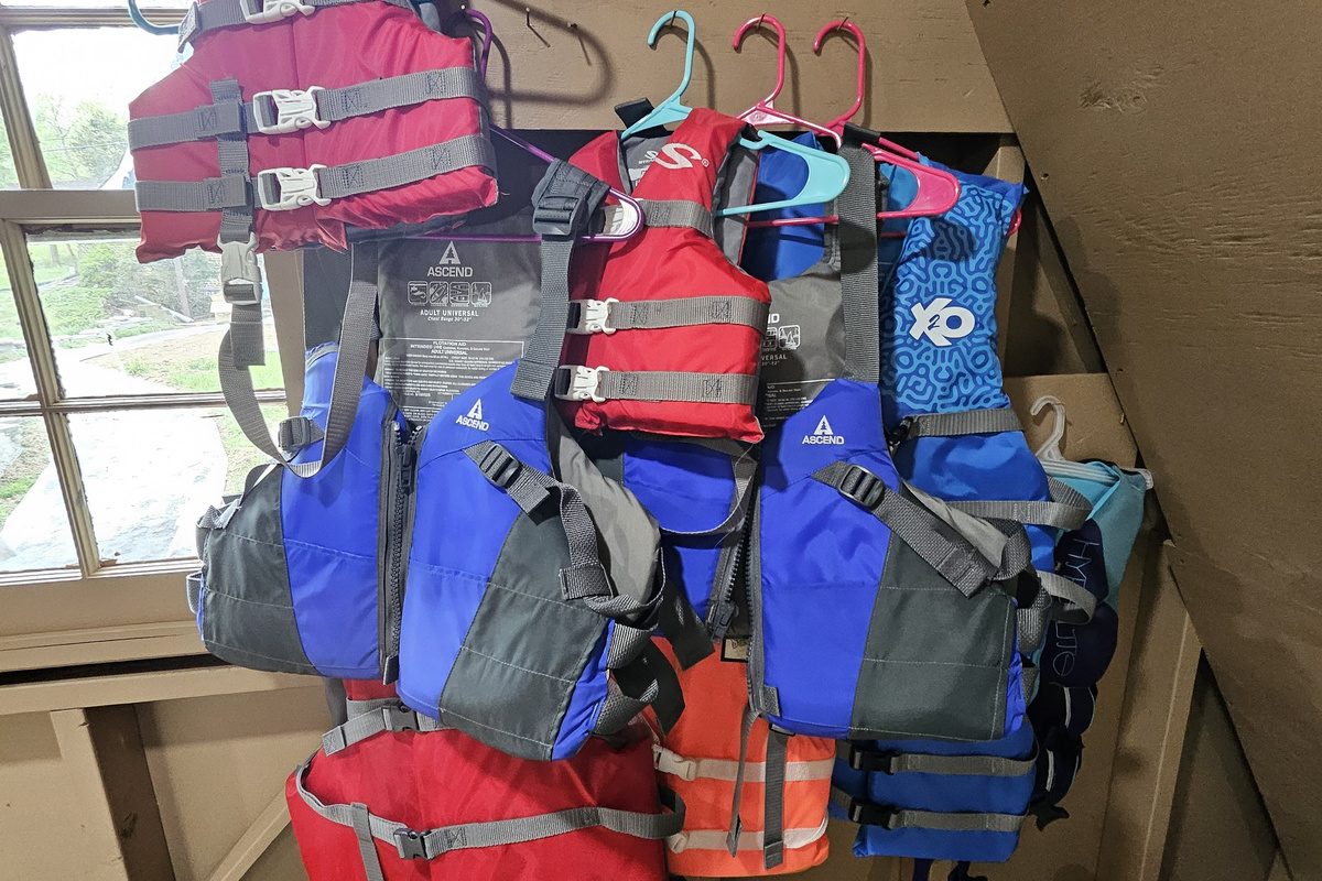 A variety of adult and child life vests are located in the boathouse.
