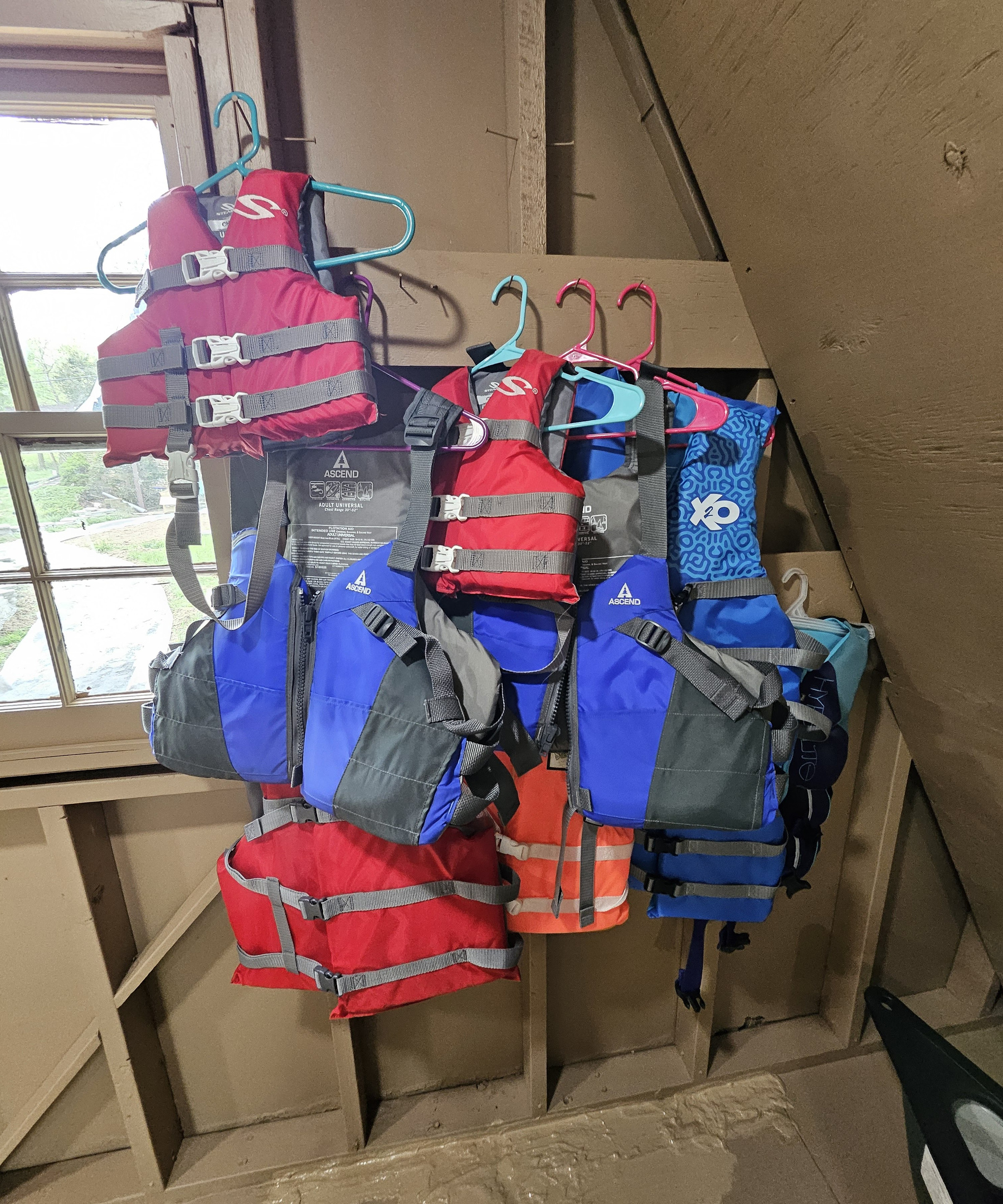 A variety of adult and child life vests are located in the boathouse.
