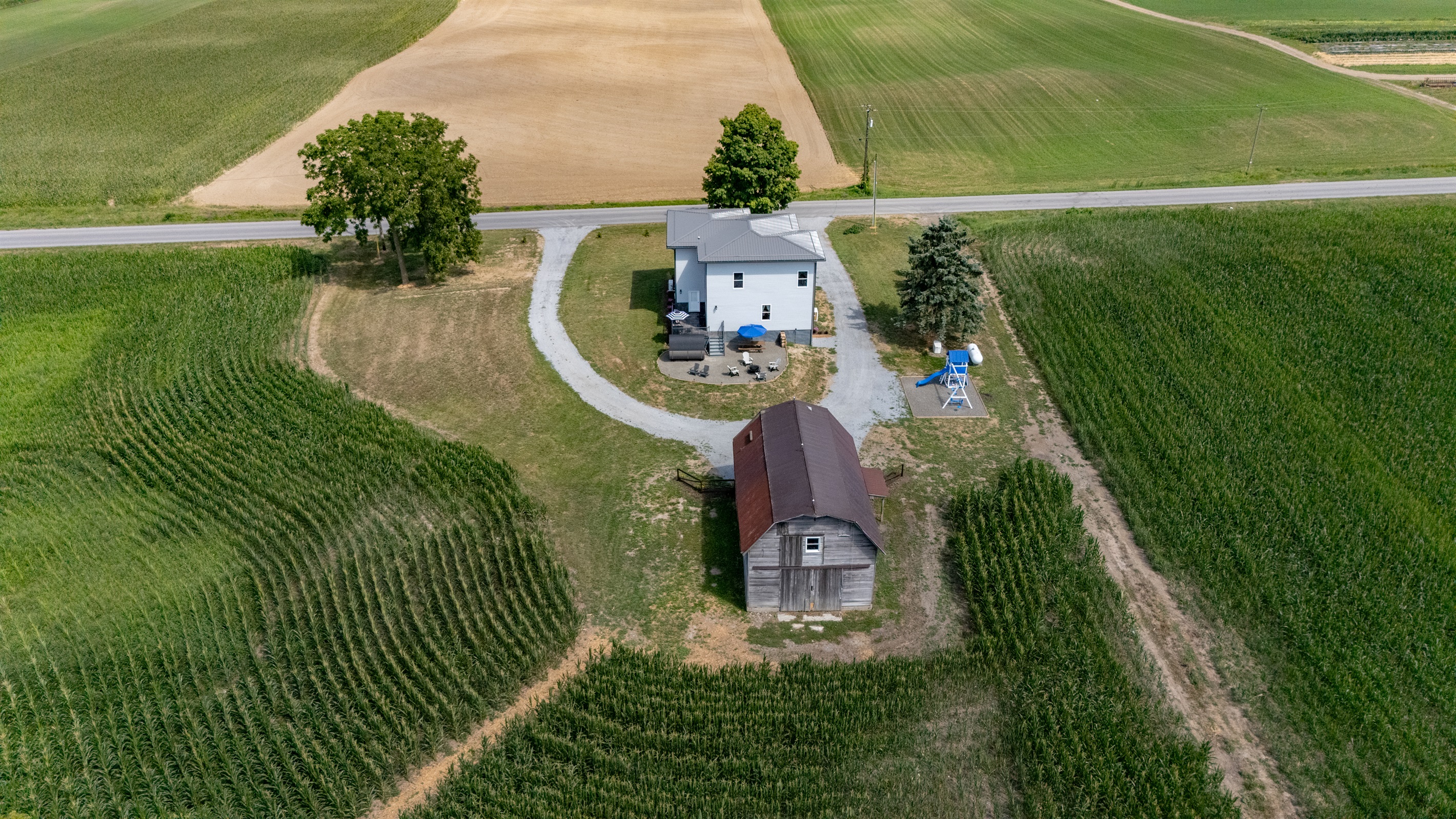 Expansive country charm with wide-open fields, private driveway, and a peaceful homestead retreat surrounded by nature.