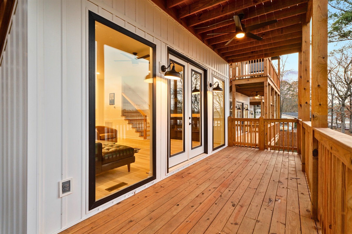 Large doors connect the indoor living space directly to the deck for easy outdoor access.
