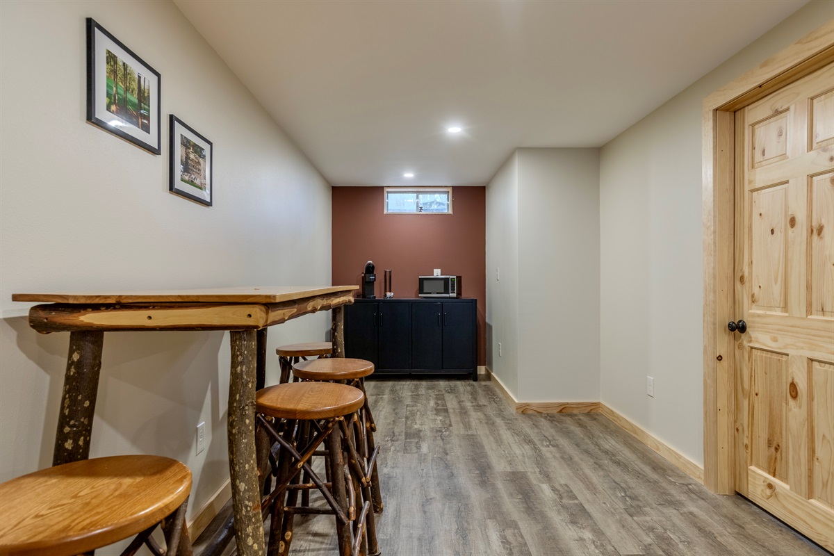 Basement living area with space to hang out, king bedroom, bathroom, electric fireplace, microwave, K-cup coffee maker and smart TV.
