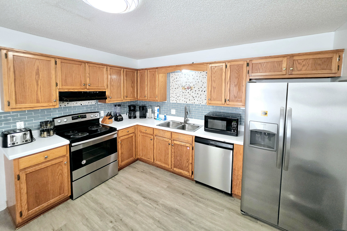 Kitchen with stainless appliances and tile backsplash