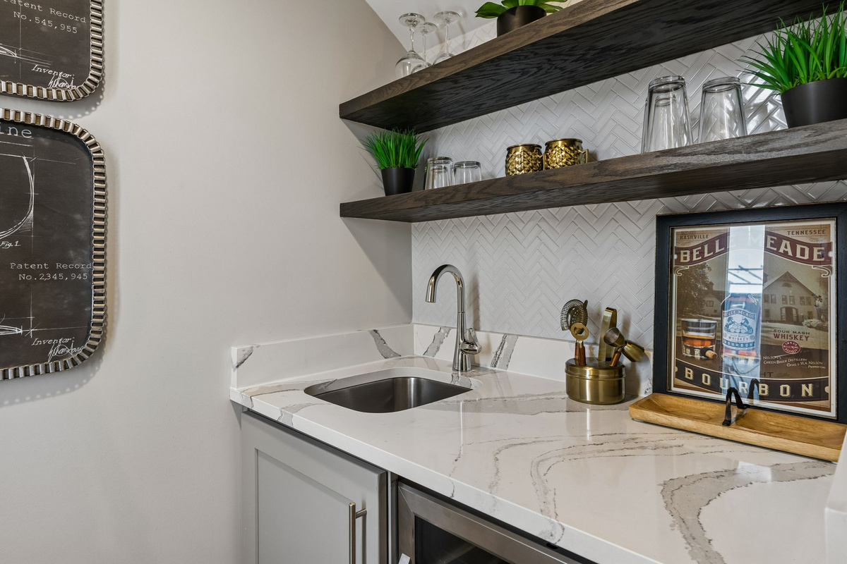 Stock the rooftop wet bar and you won't need to go back downstairs &mdash; quartz counter, glassware ready, beverage fridge stocked, and the skyline waiting.