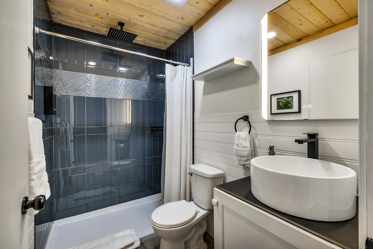 Enjoy a refreshing shower in this bright, modern bathroom with a spacious walk-in shower and clean, contemporary finishes.