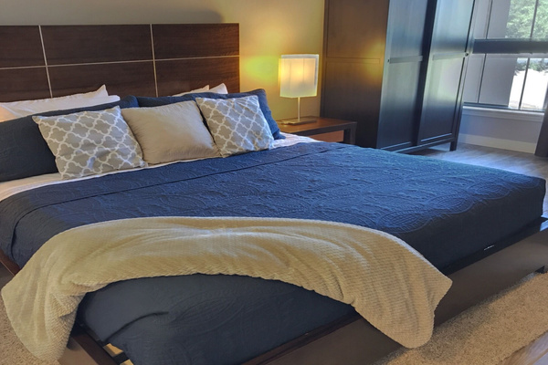 New California king bed with soft linens and plenty of storage.