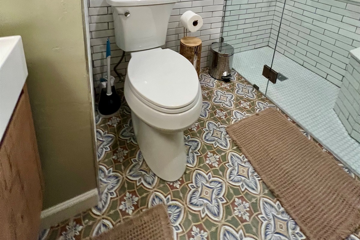 Refresh in your private, spa-like bathroom, featuring a modern walk-in shower and designer tile.
