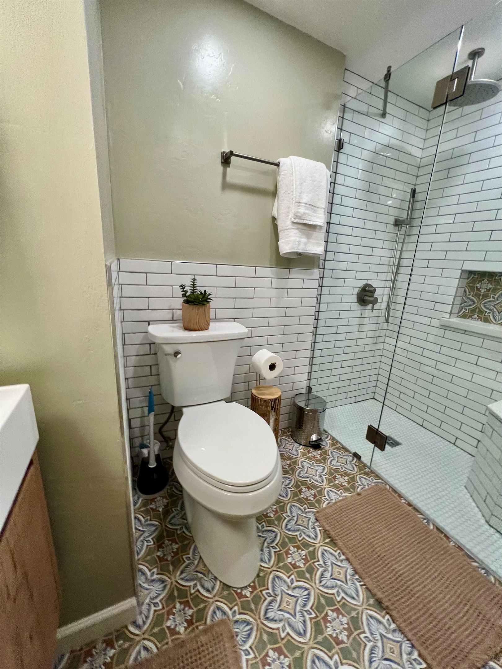 Refresh in your private, spa-like bathroom, featuring a modern walk-in shower and designer tile.