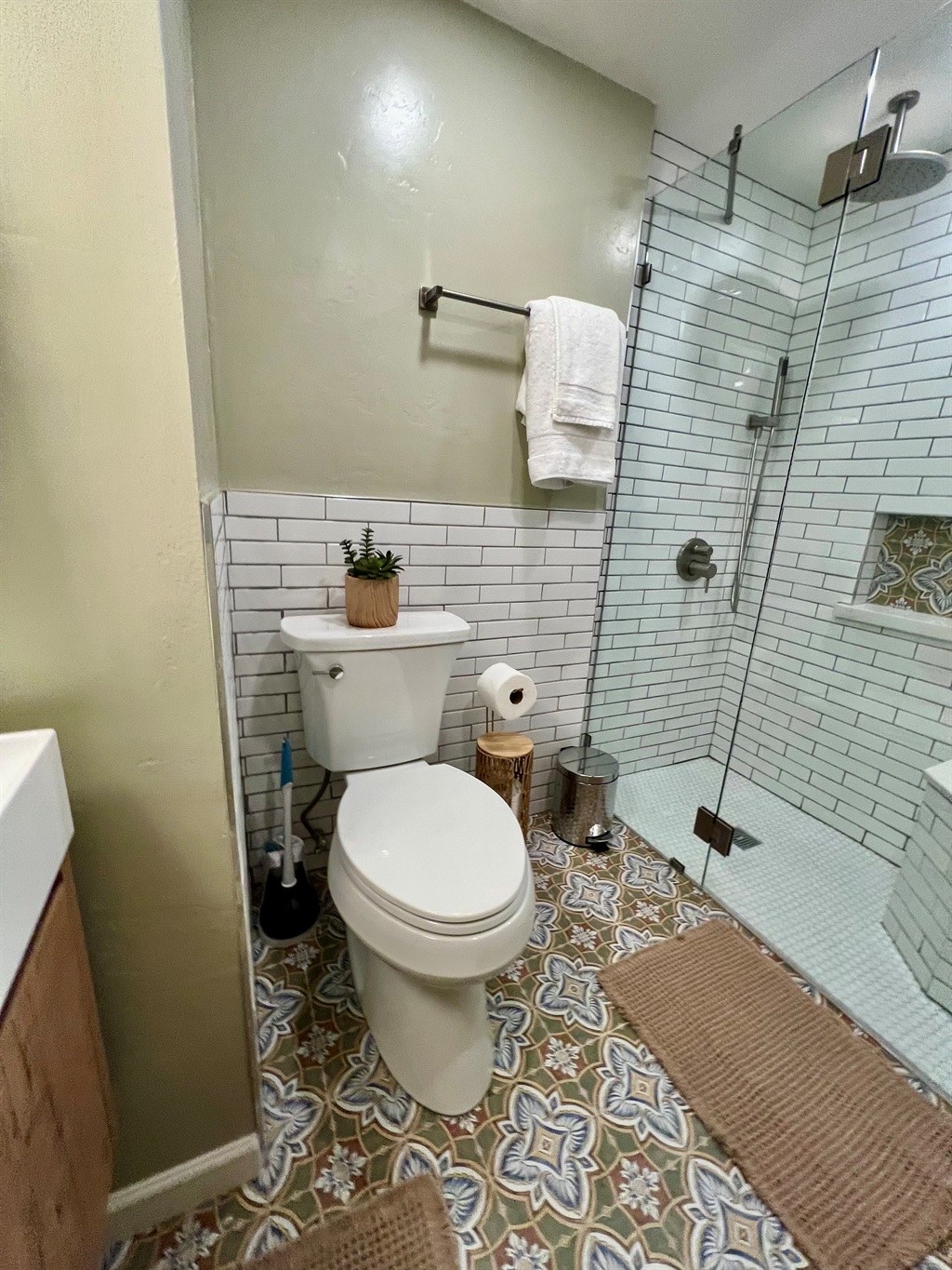 Refresh in your private, spa-like bathroom, featuring a modern walk-in shower and designer tile.