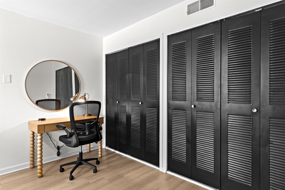 Functional setup with a desk, chair, and ample closet space for extended stays.