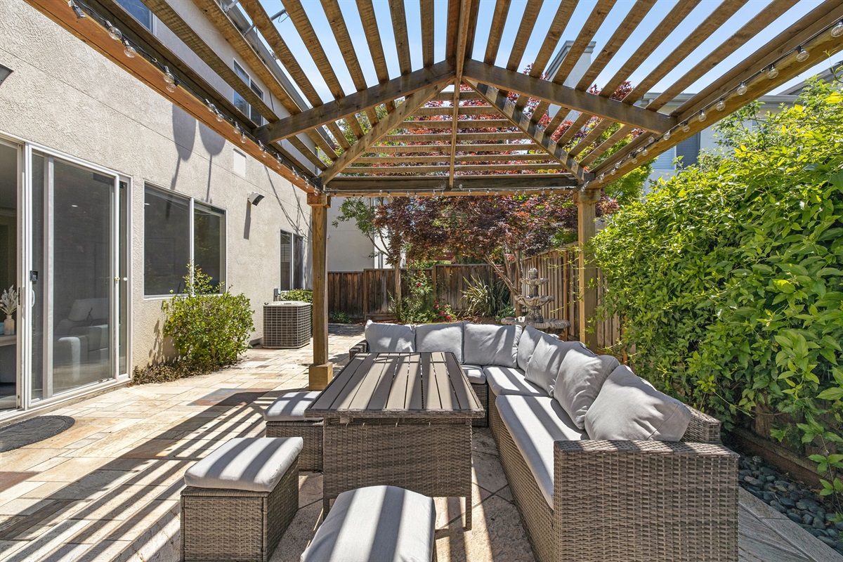 Relax and enjoy the outdoors  in this charming backyard.