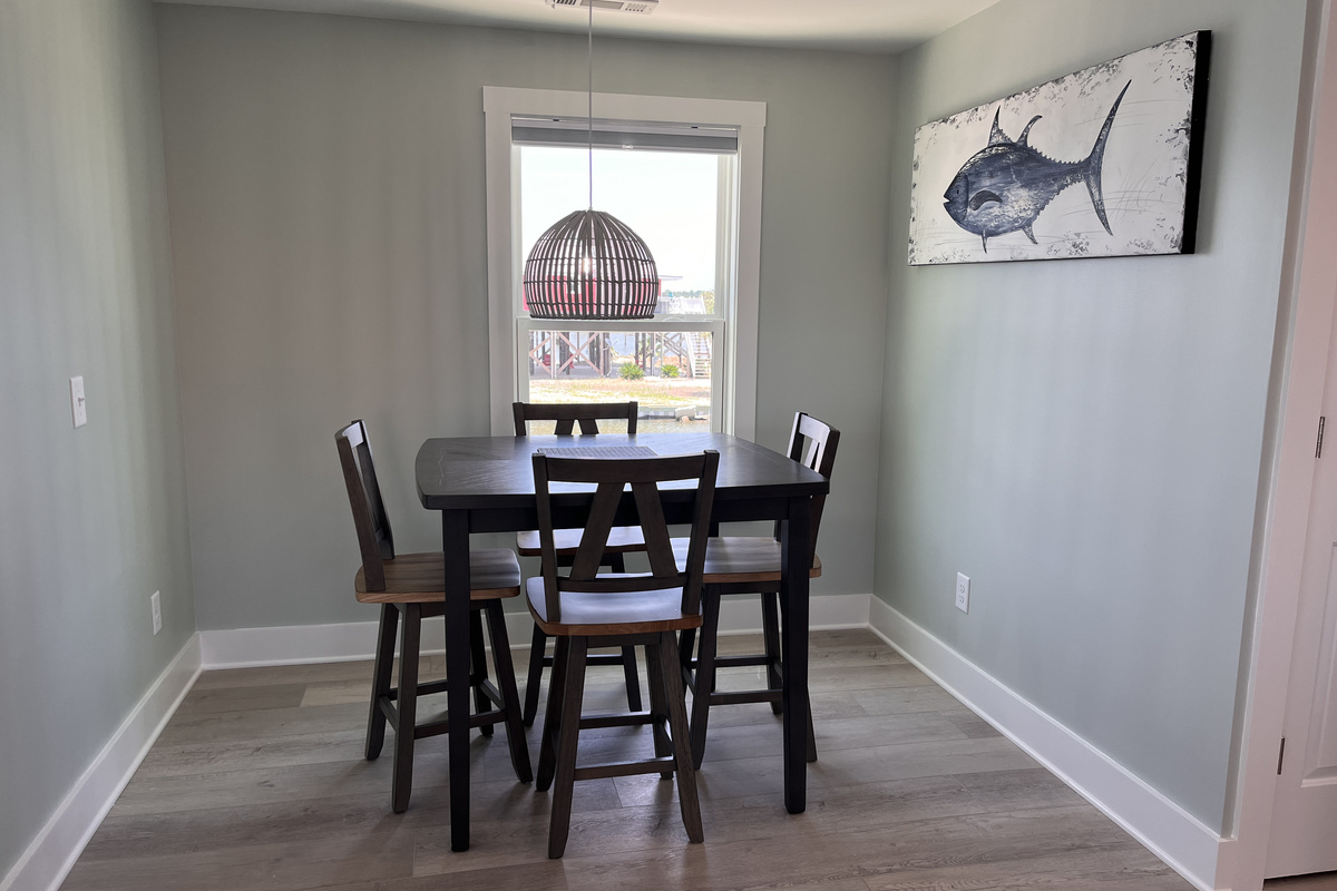 Dining area featuring seating for four and breathtaking bay views.
