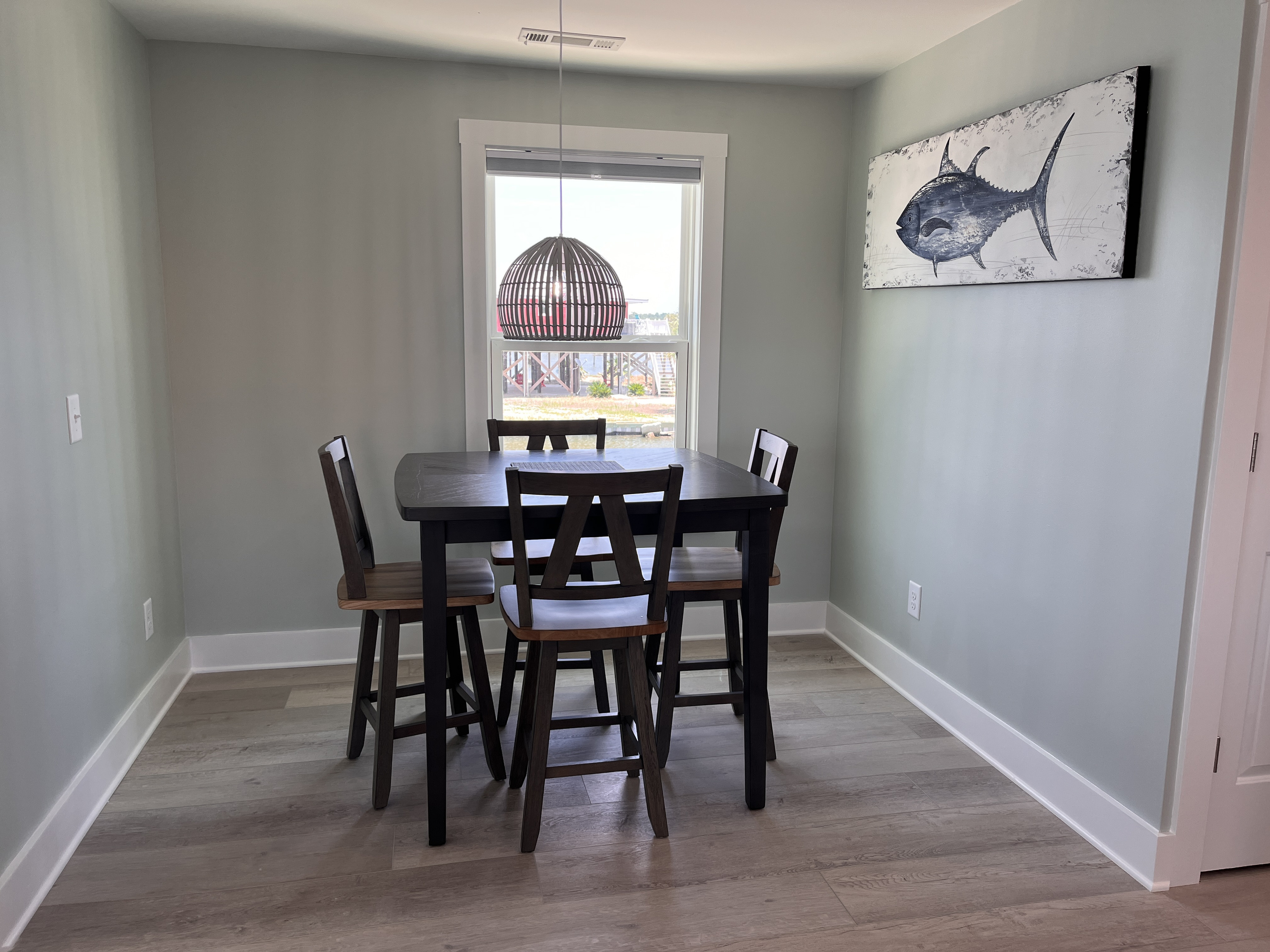 Dining area featuring seating for four and breathtaking bay views.
