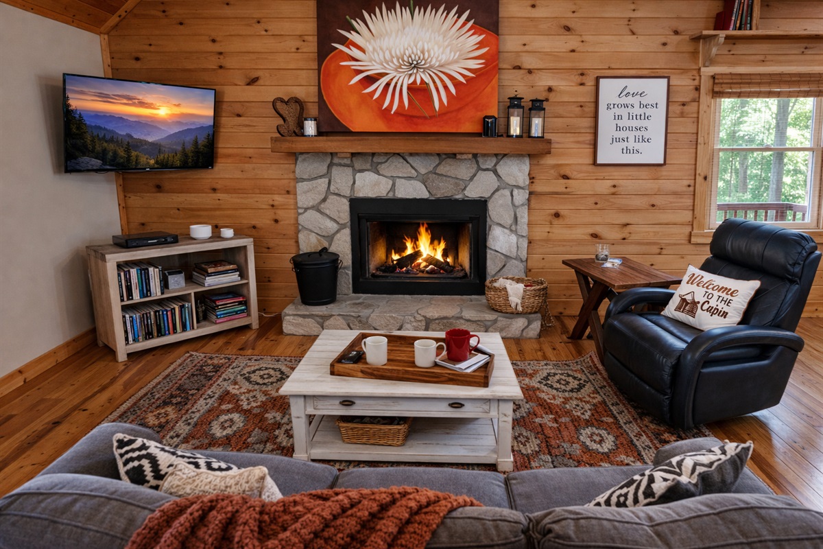 Cozy nights by the stone fireplace in this warm mountain cabin living room.