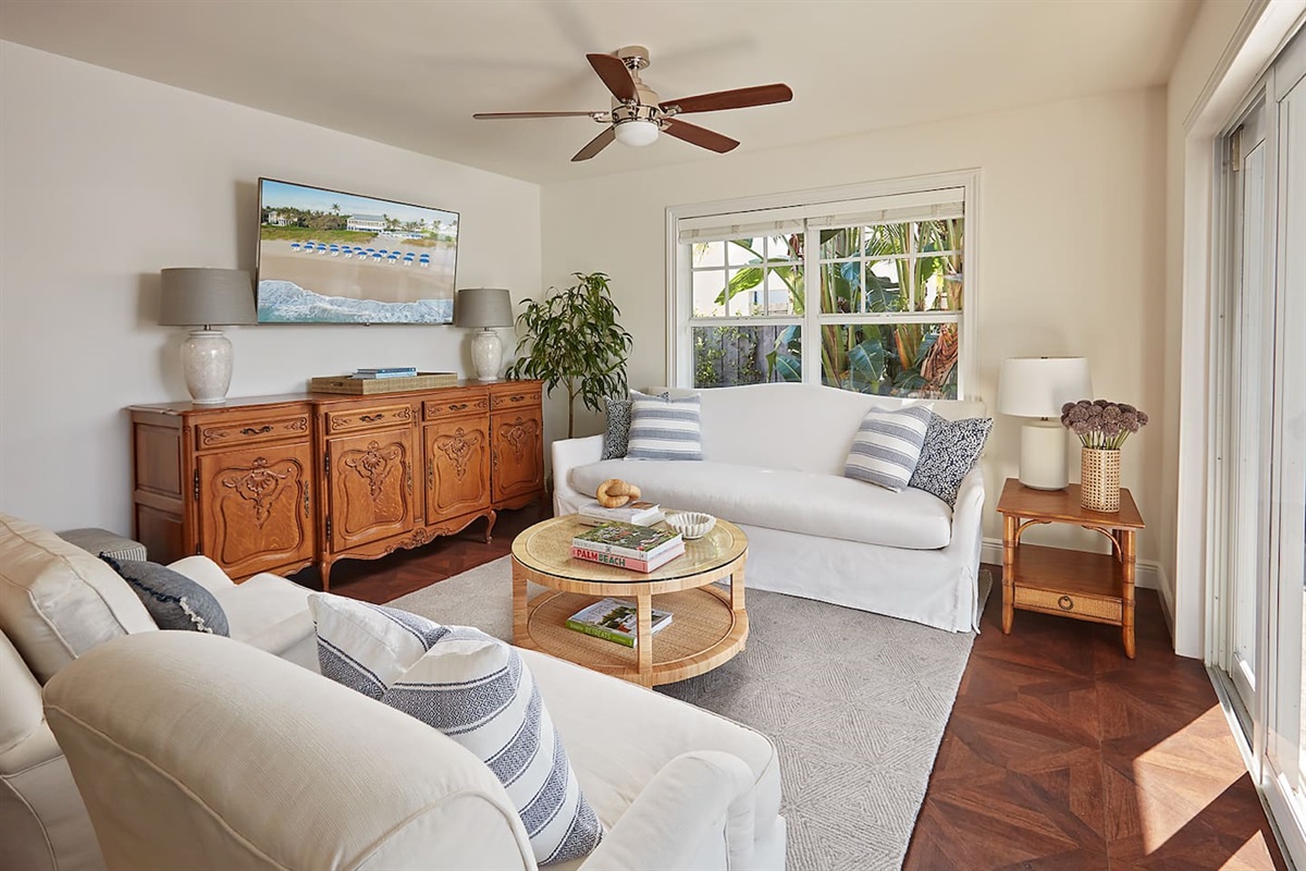 An extra-comfortable living room featuring a plush sofa, two cozy club chairs, and a smart TV—perfect for unwinding after a full day of activities.