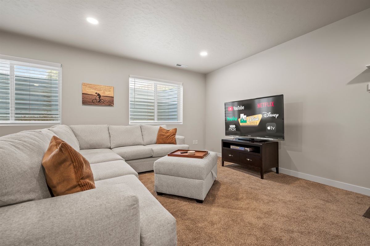 The downstairs living room features a large TV with streaming capabilities—perfect for cozy nights in and watching your favorite shows.