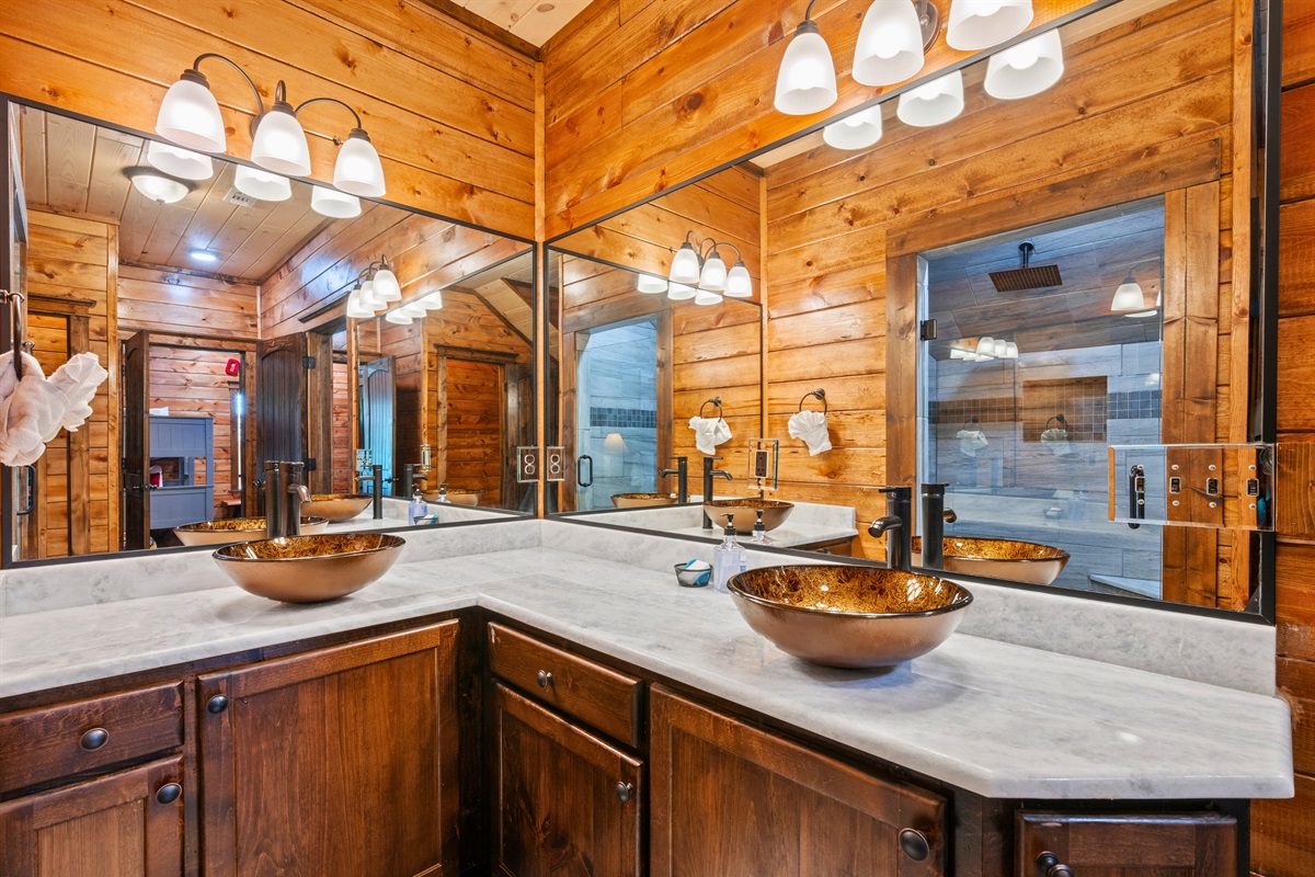 Bright lighting and a thoughtfully designed vanity area ensure everyone has the space they need, adding both style and function to this bathroom.