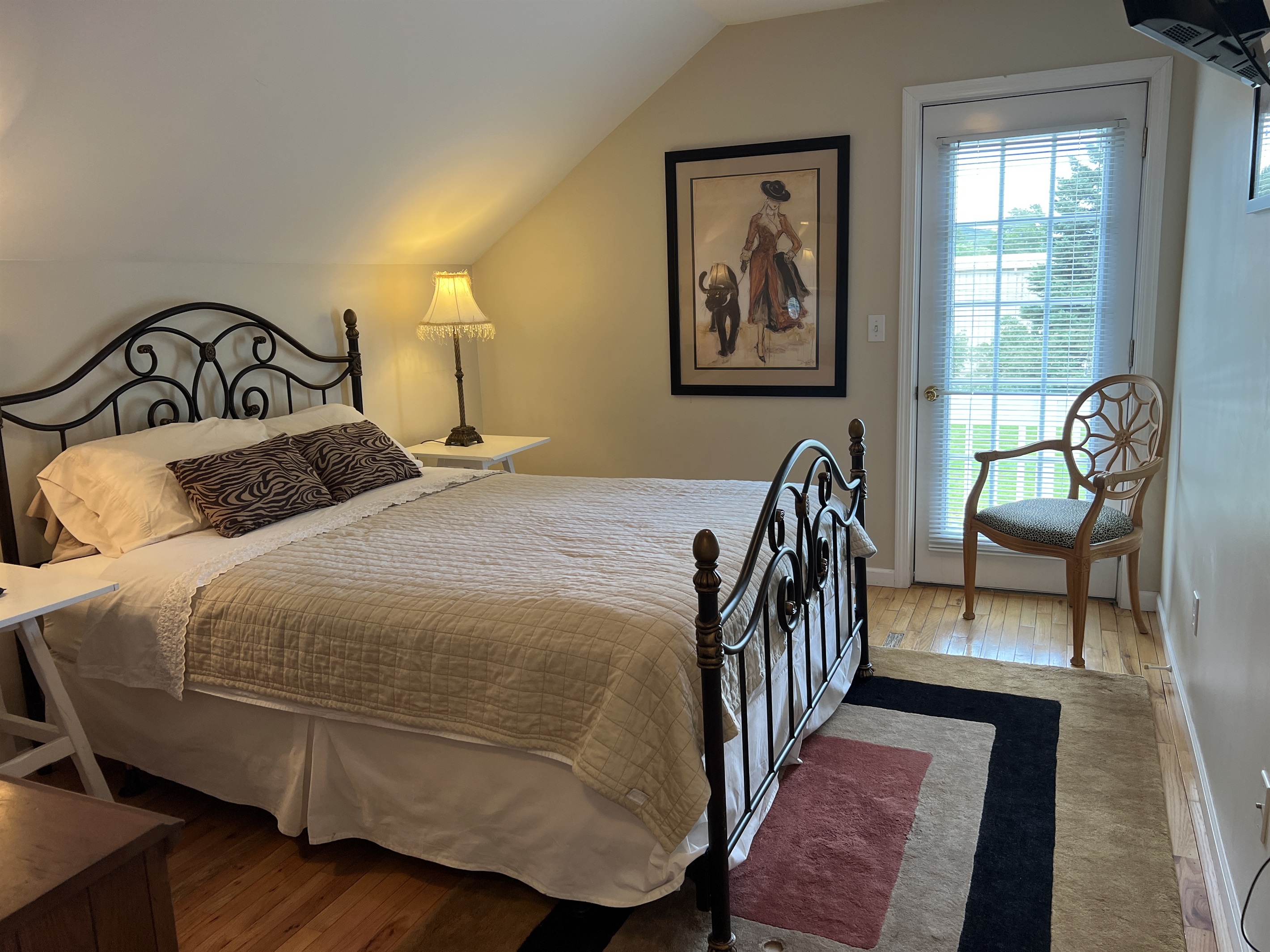 The Federal House Apartment 2, 2nd floor bedroom #2 with smart TV and access to the balcony.