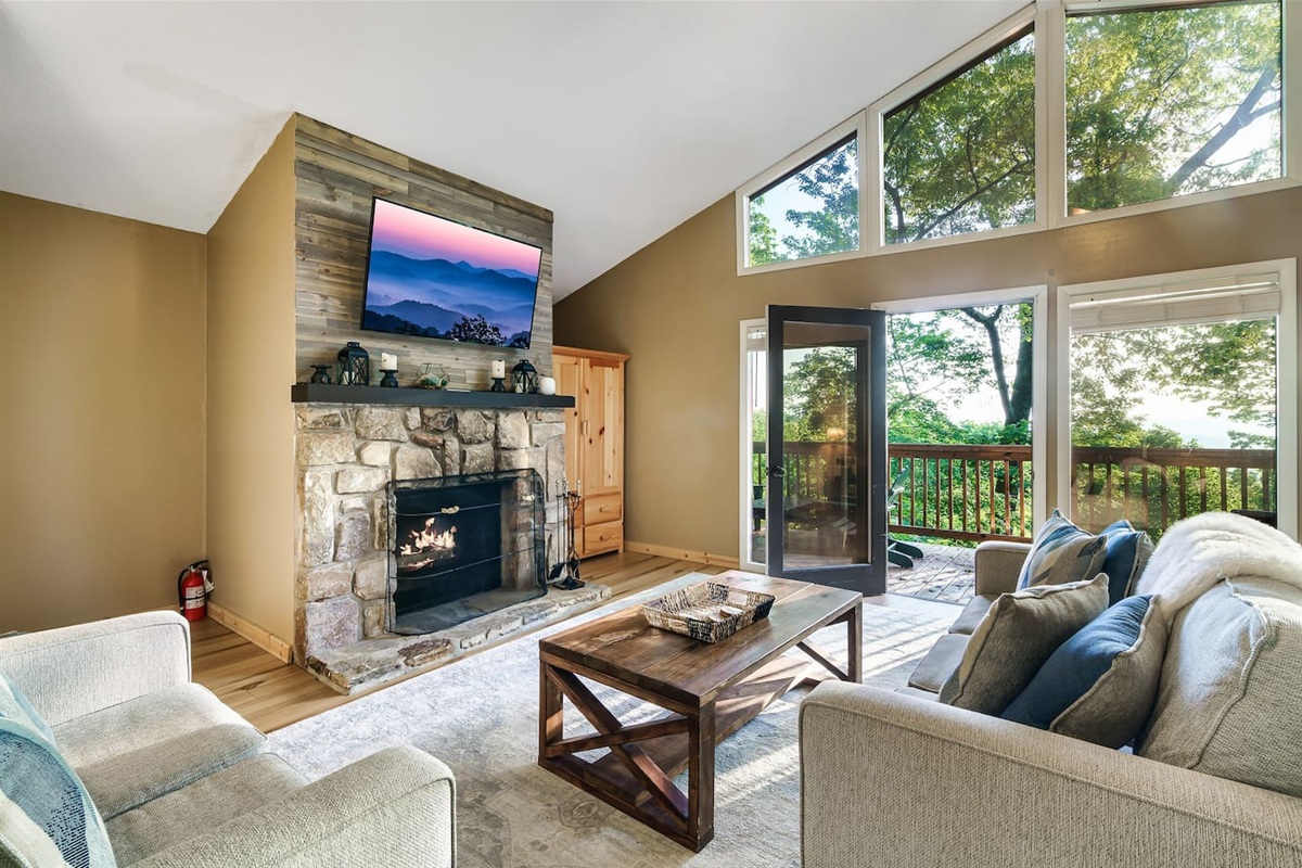 Living area inside the top floor private master bedroom suite. The stone fireplace is a real wood-burning fireplace.