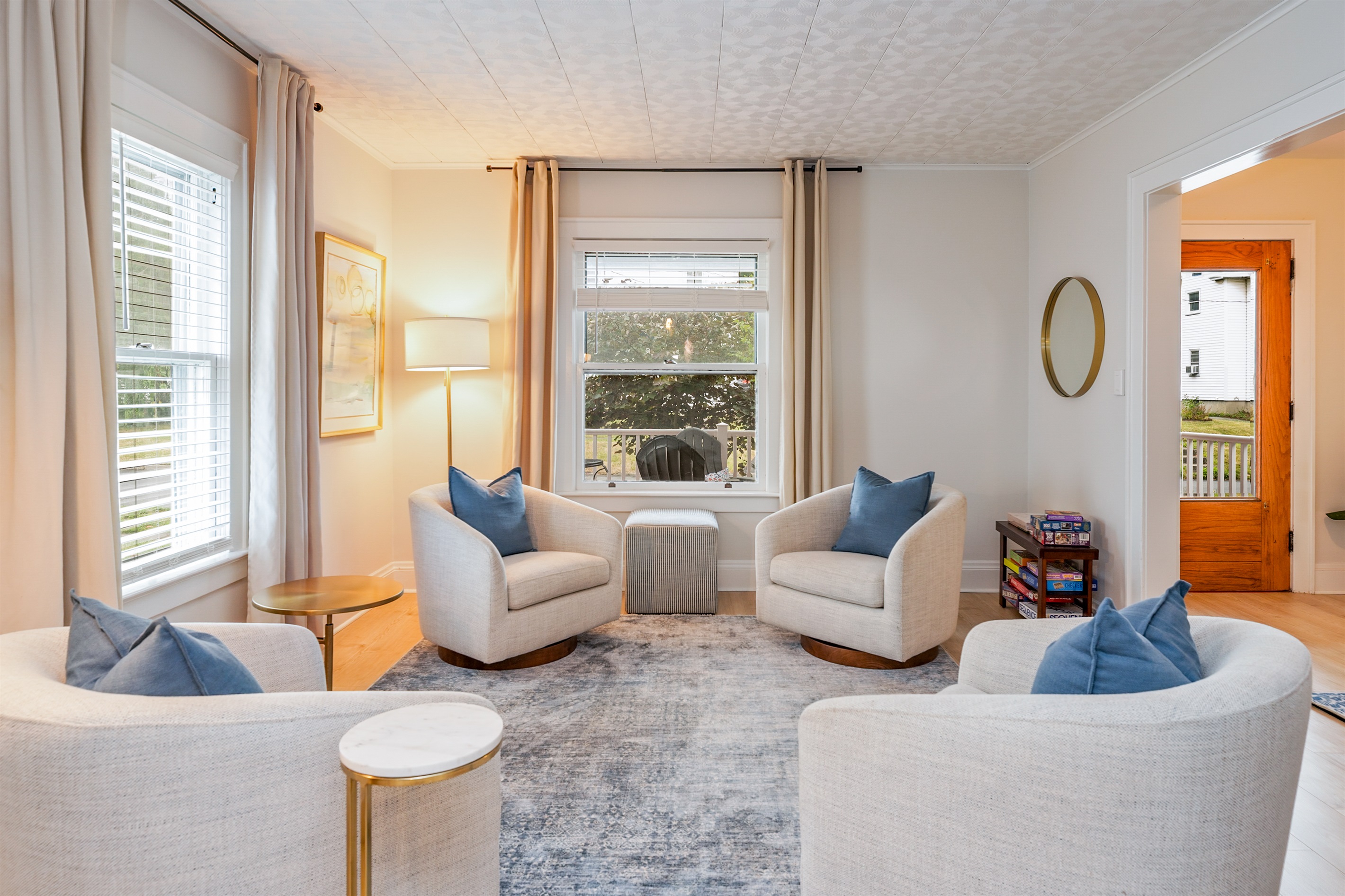 Bright and airy living space with plush seating, modern art, and peek-through to the elegant dining area—perfect for entertaining or relaxing.